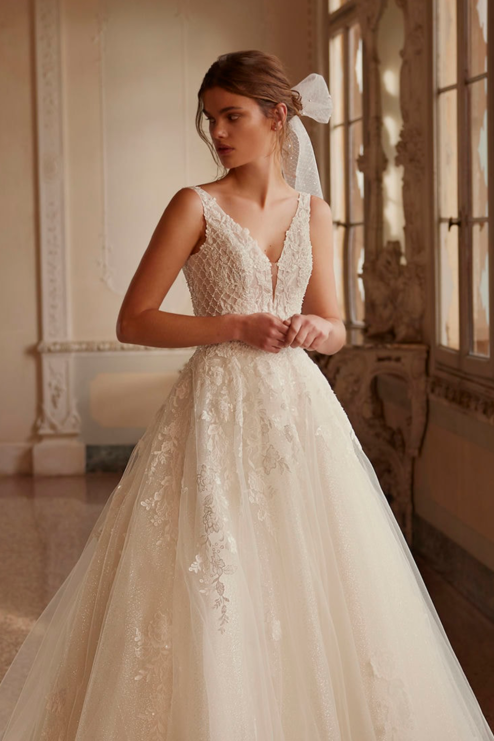 Model wearing white Demetrios dress