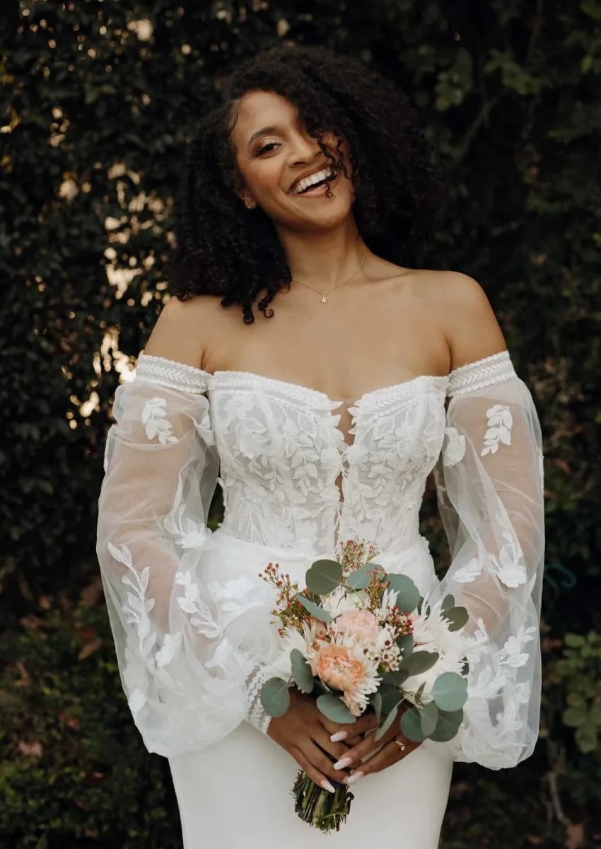 Model wearing white Stella York dress