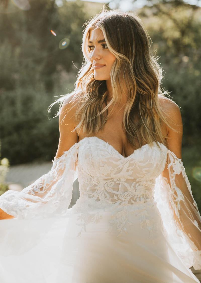 Model wearing white Stella York dress