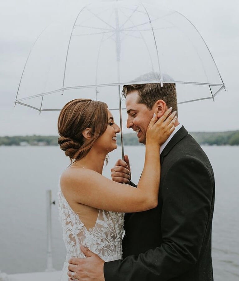 Сouple wearing a white gown and a black suit