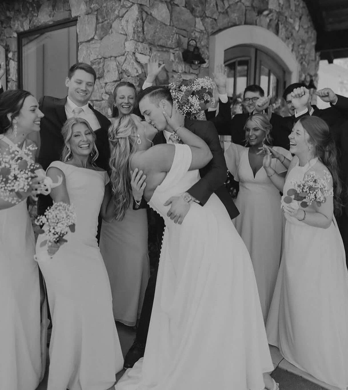 Сouple wearing a white gown and a black suit