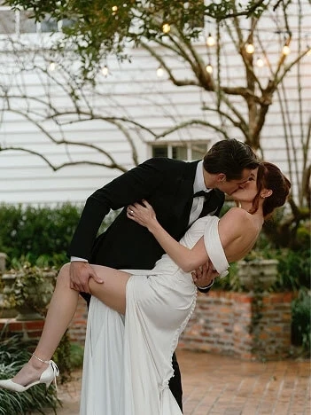 Сouple wearing a white gown and a black suit on the street