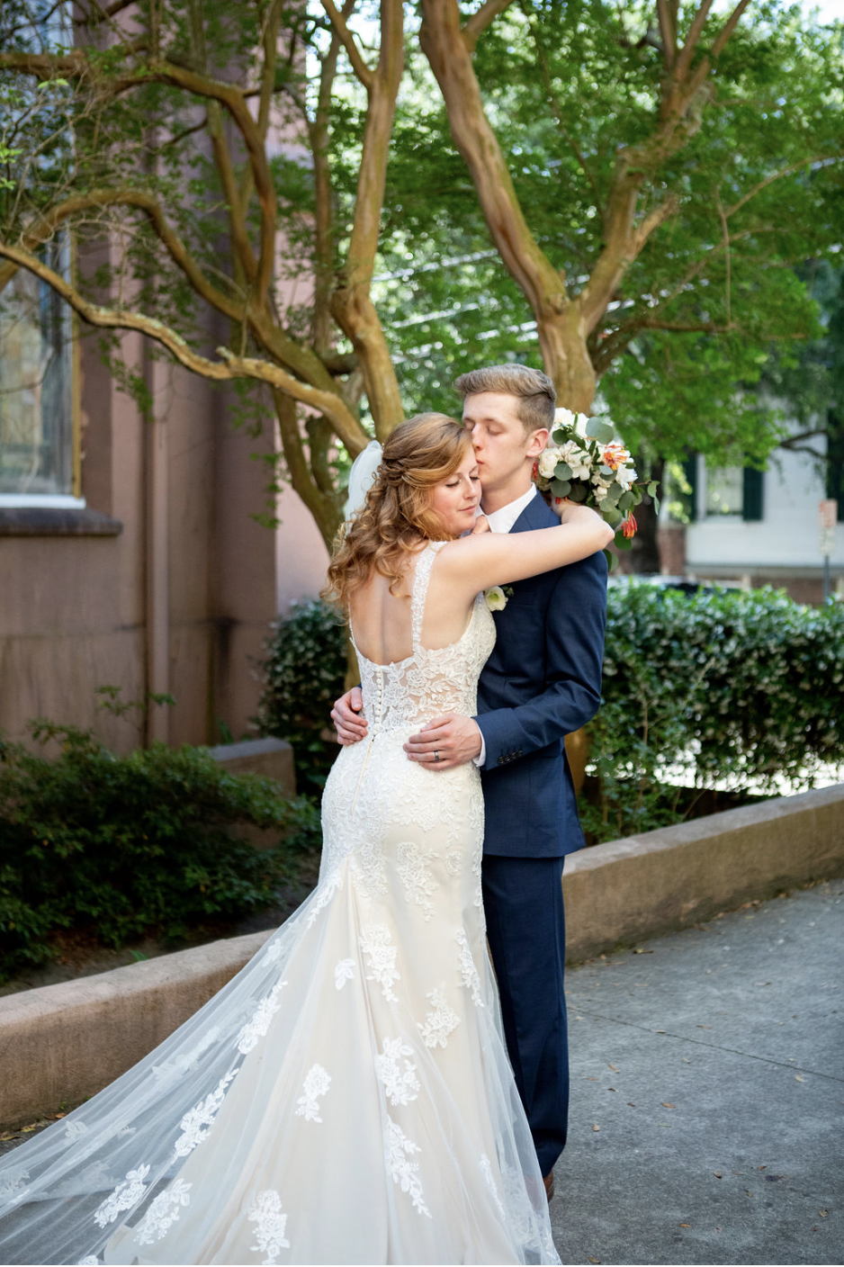 Сouple wearing a white gown and a black suit