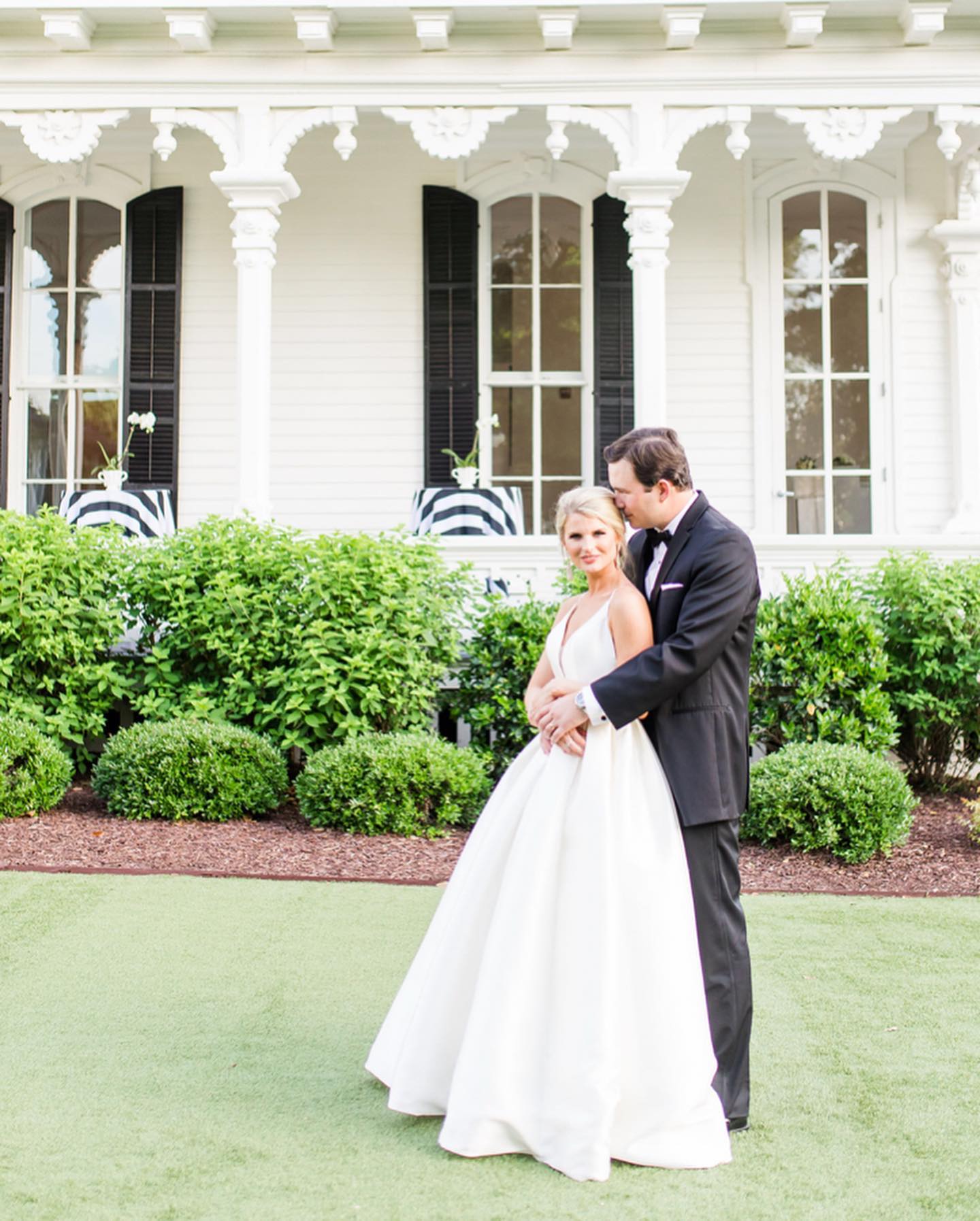 Сouple wearing a white gown and a black suit