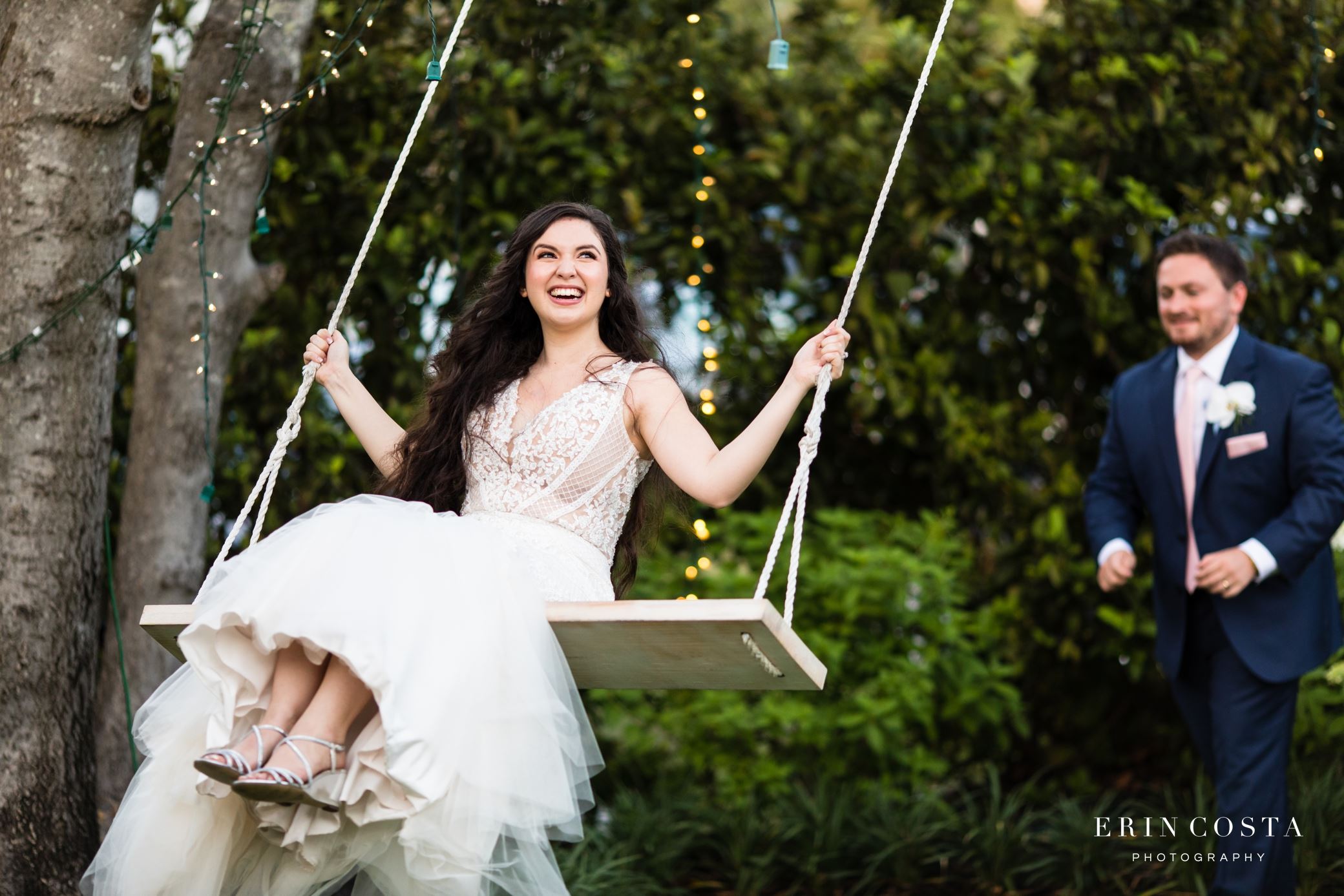 Model wearing a white gown on the swing