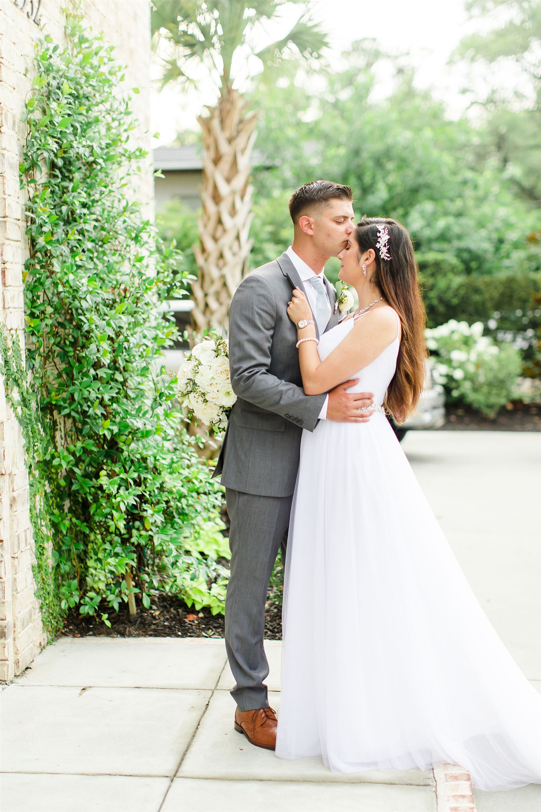 Сouple wearing a white gown and a gray suit