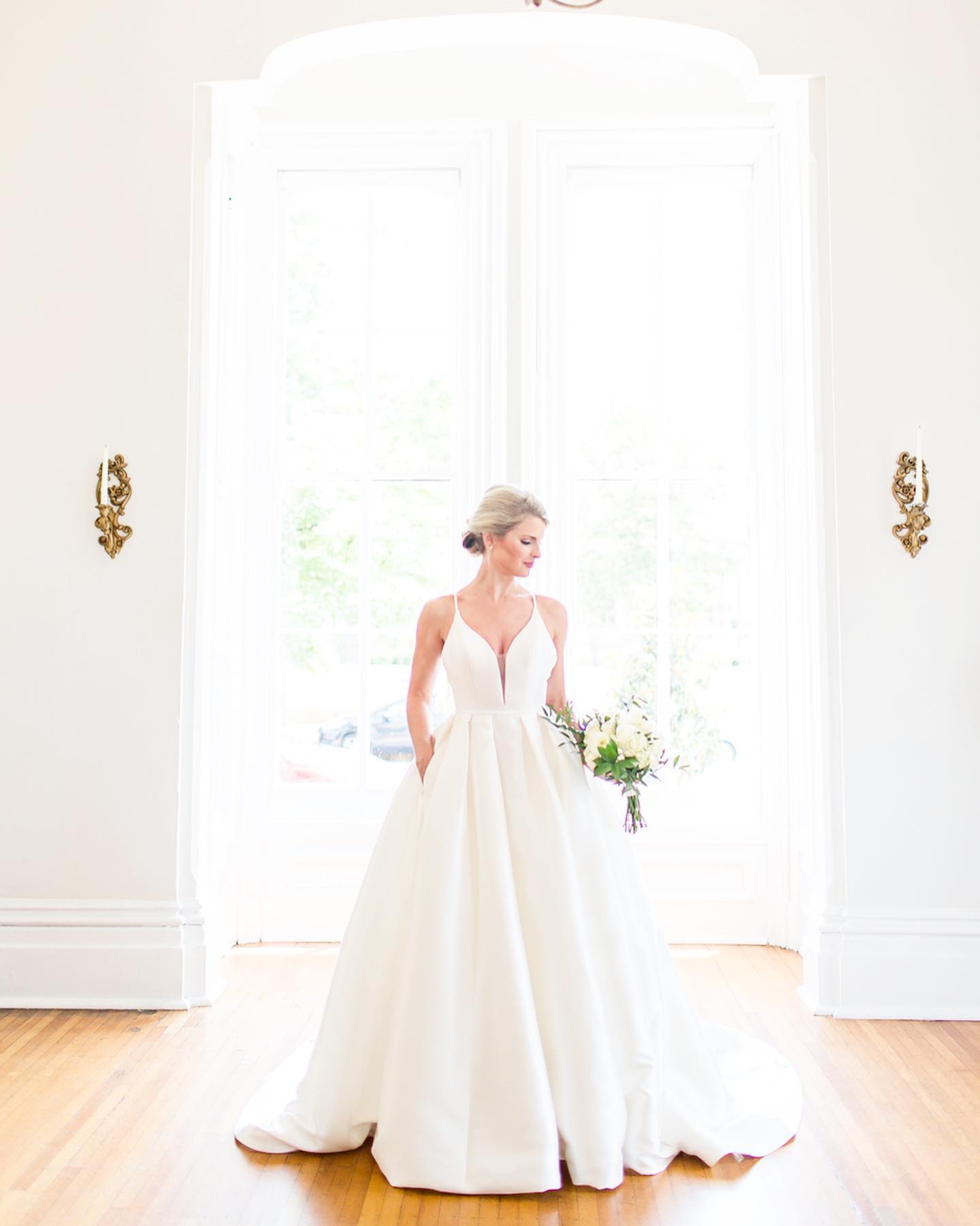 Model wearing a white gown at home